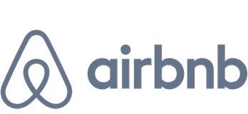A grey logo of Airbnb.