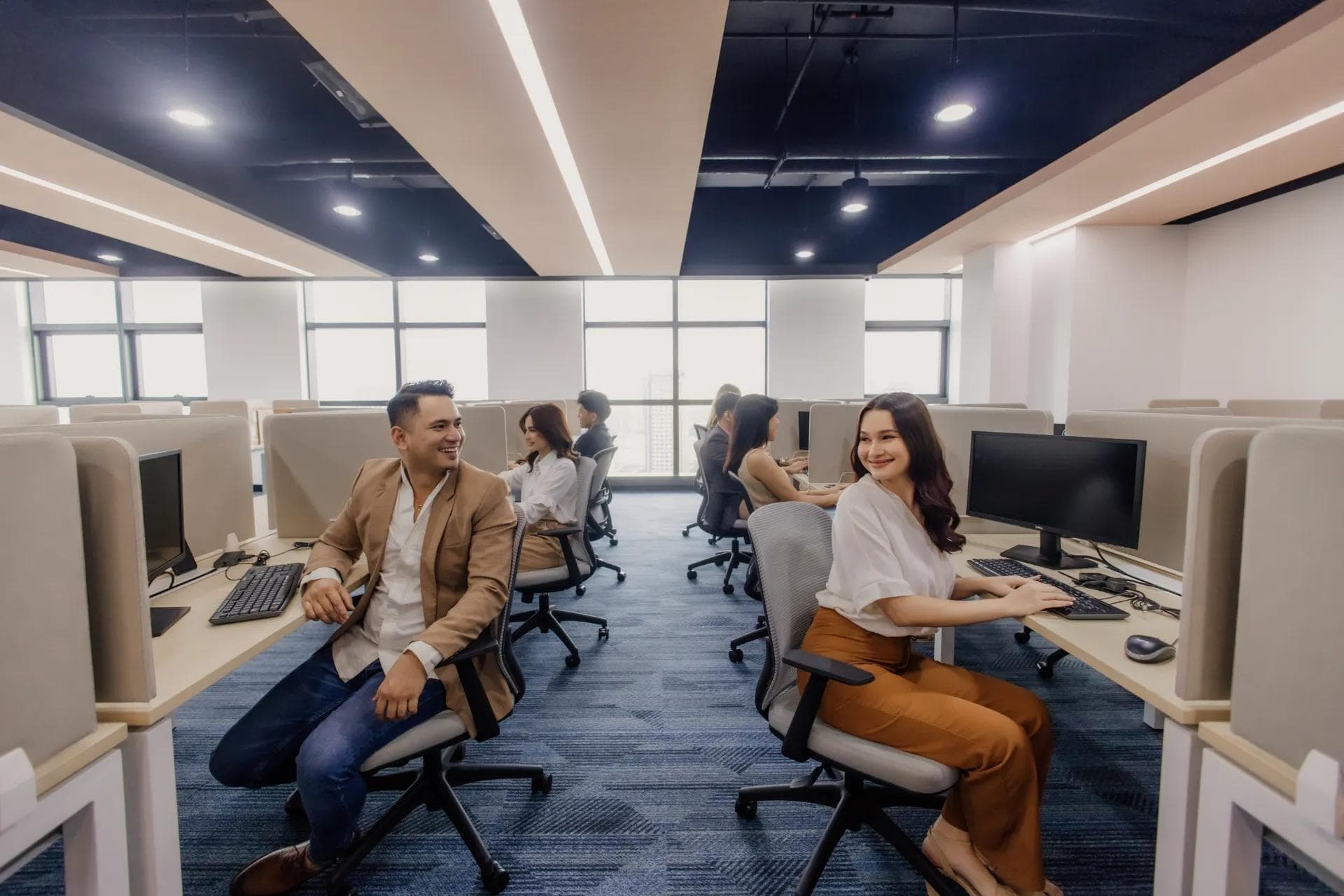 A modern office with professionals in an organized workspace, showcasing the efficiency of offshore teams in the Philippines.