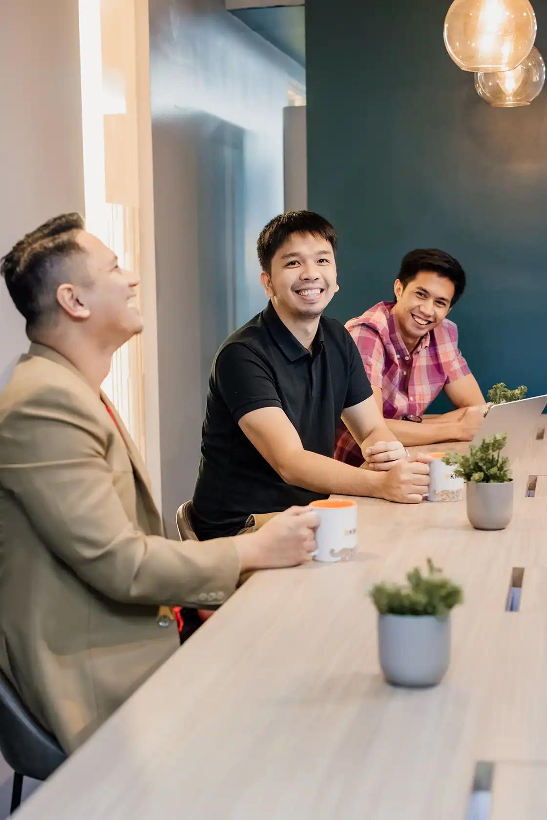 Colleagues at a business lounge discuss strategies, reflecting KMC's commitment to world-class talent and workforce solutions. Colleagues at a business lounge discuss strategies, reflecting KMC's commitment to world-class talent and workforce solutions.