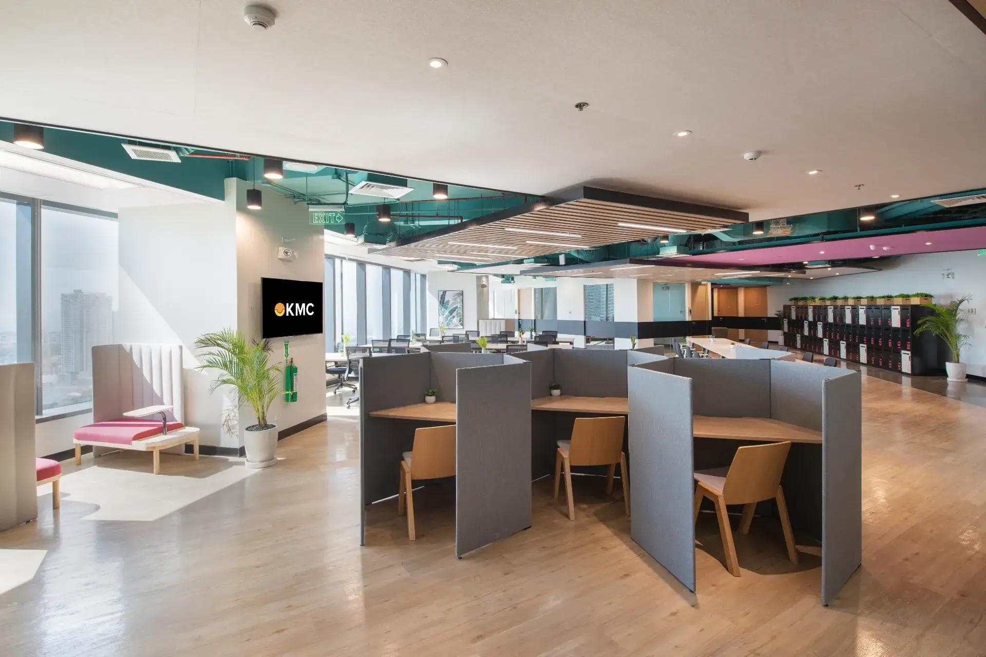 Modern KMC coworking space in Mandaluyong with privacy pods, open seating, and large windows for natural light.