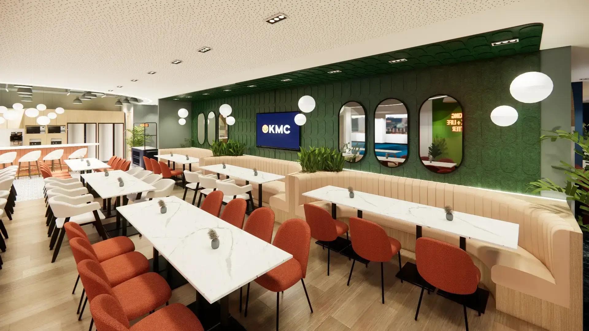 Modern coworking lounge with white marble tables, orange chairs, green accent wall, mirrors, and KMC logo on screen.