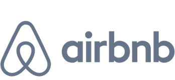 A grey logo of Airbnb.